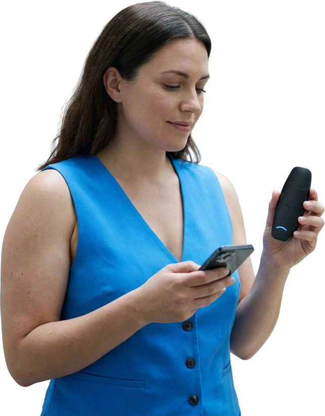 A woman holding the Rysflo breath device and reading her result on her phone