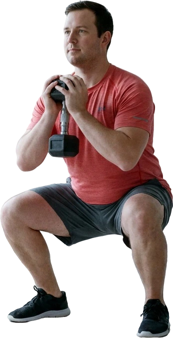 A man at the bottom of a goblet squat
