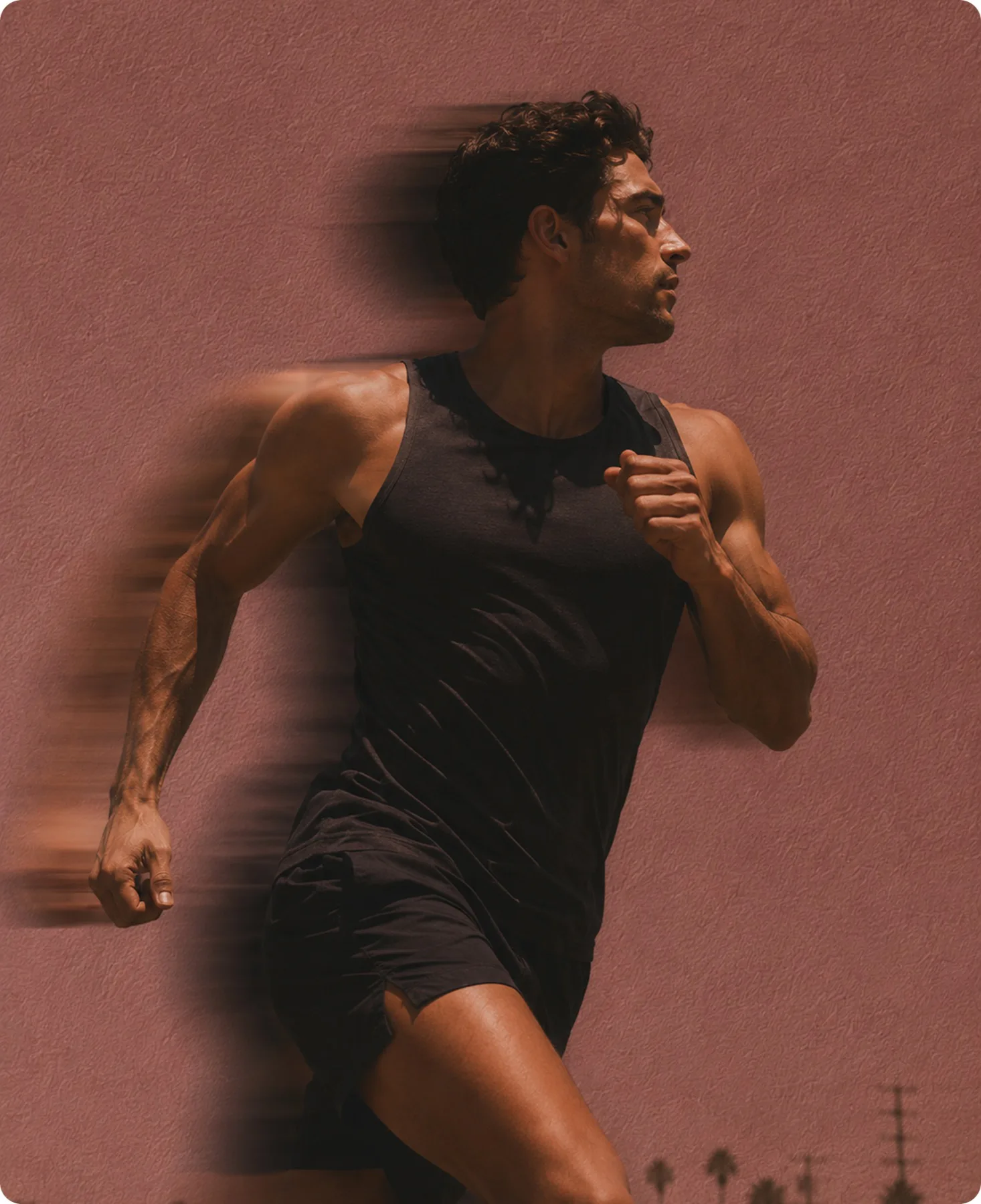 A runner at full effort, mid-stride and motion-blurred